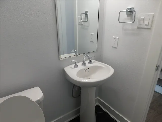 a bathroom with a sink and mirror