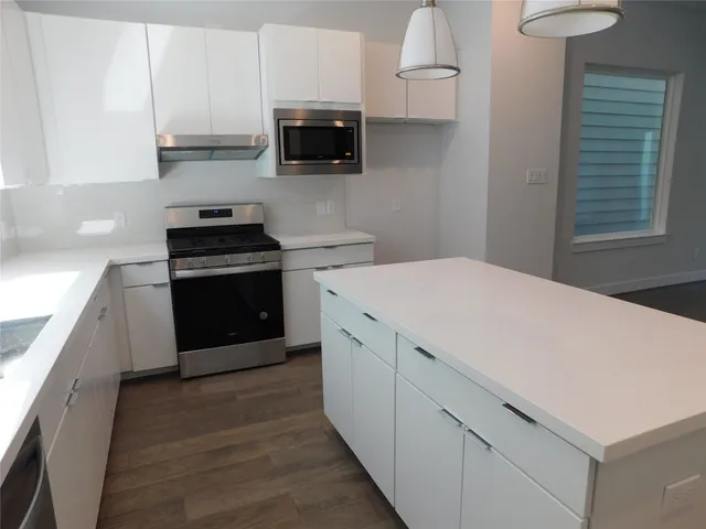 a kitchen with a stove and a microwave