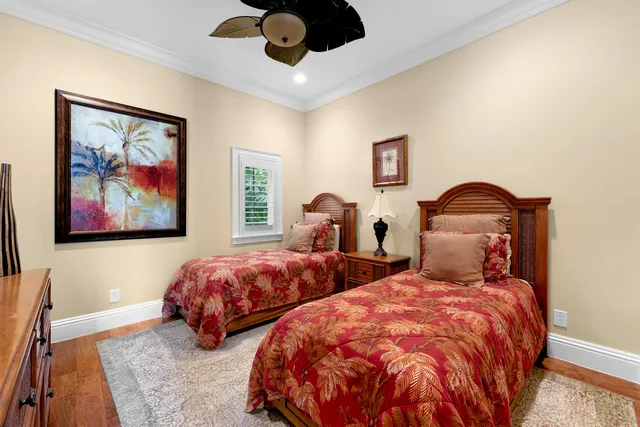 a bedroom with bed and wooden floor