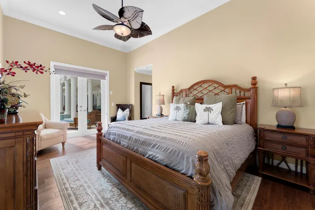 a bedroom with a bed couch and a large window