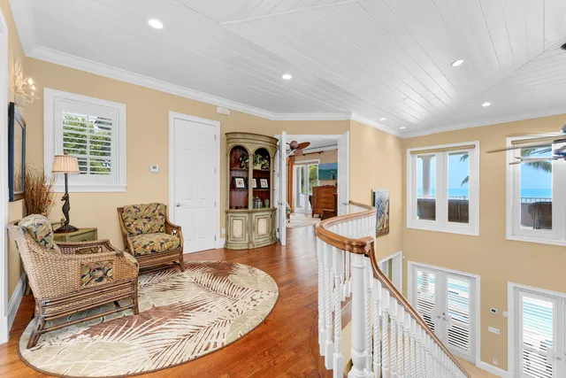 a spacious bathroom with a granite countertop sink toilet a large mirror and a bathtub