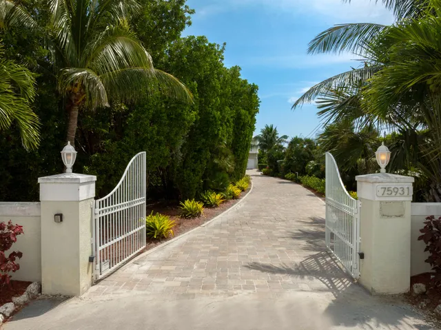 a front view of house with yard and trees around