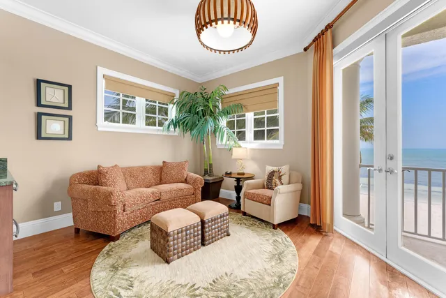 a living room with furniture and large windows