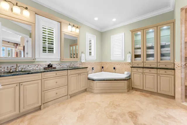 a view of a patio with table and chairs and floor to ceiling window