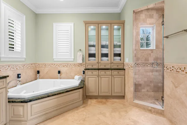 a view of a patio with couches table and chairs with wooden floor and fence