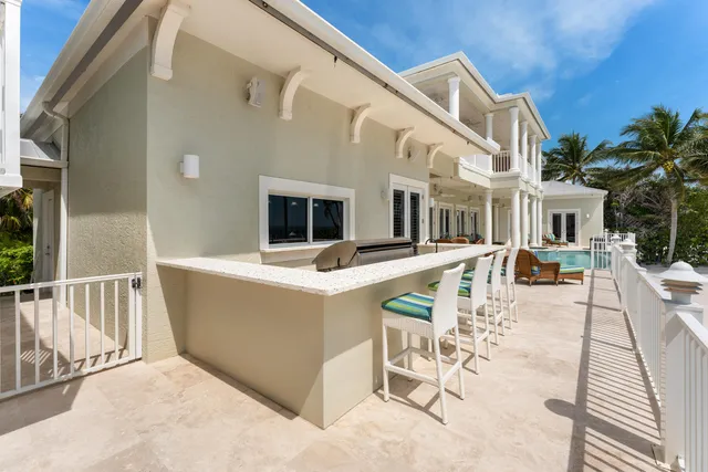 a view of a house with swimming pool and porch with furniture