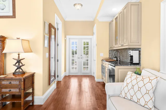 a front view of a building with a palm tree