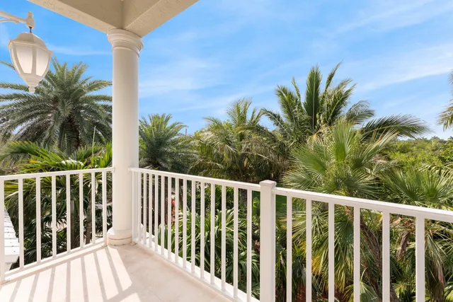 an aerial view of a house with swimming pool and ocean view