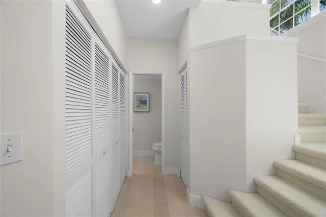 a view of a hallway with wooden floor and entryway