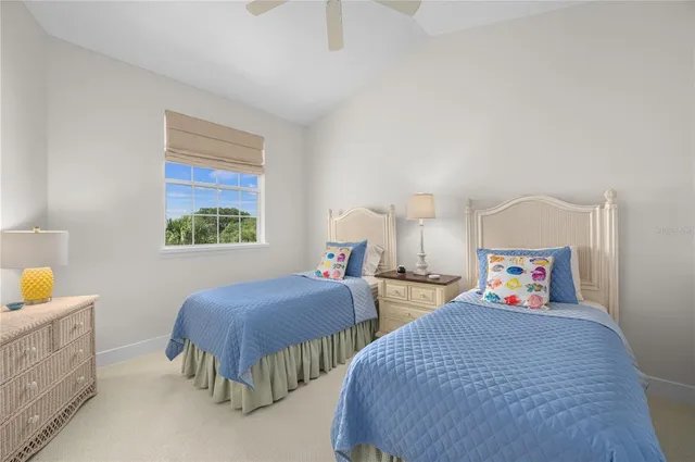 a bedroom with two beds and a window