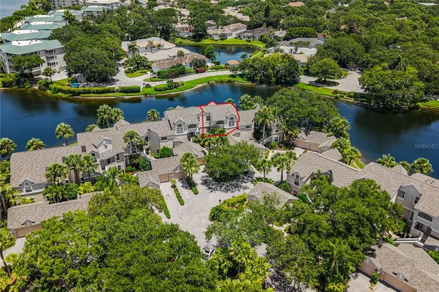 an aerial view of a house with a lake view