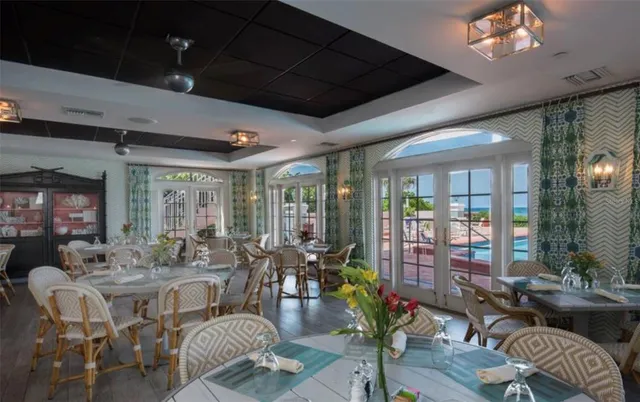 a view of a dining room with furniture wooden floor and chandelier
