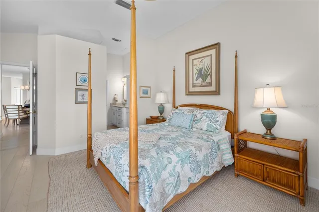 a bedroom with a bed and a lamp on table