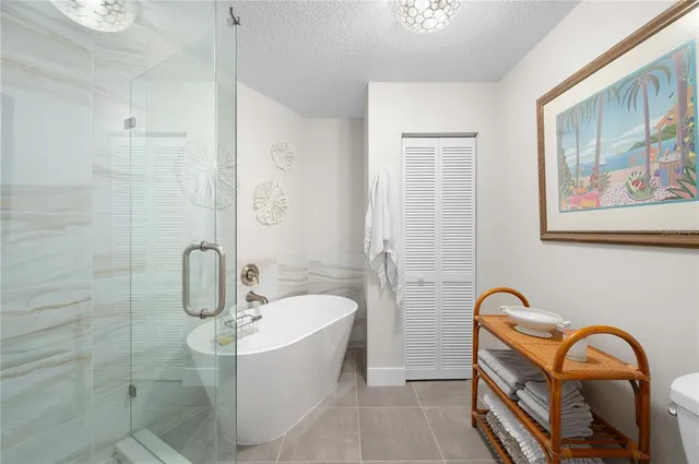 a bathroom with a tub a sink and a shower