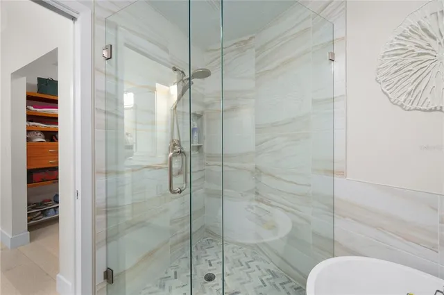 a bathroom with a toilet and a shower