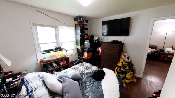 a room with furniture a flat screen tv and a window