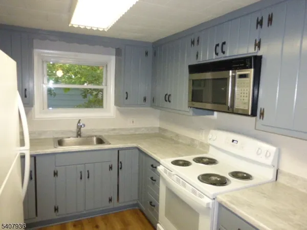 a kitchen with a sink cabinets and appliances