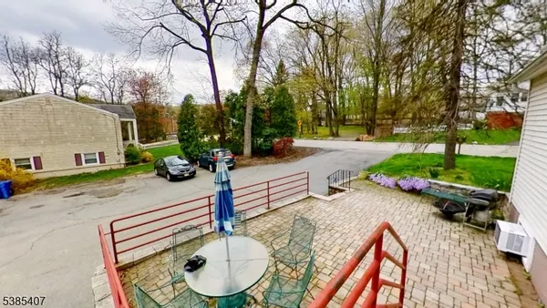 a backyard of a house with barbeque oven table and chairs