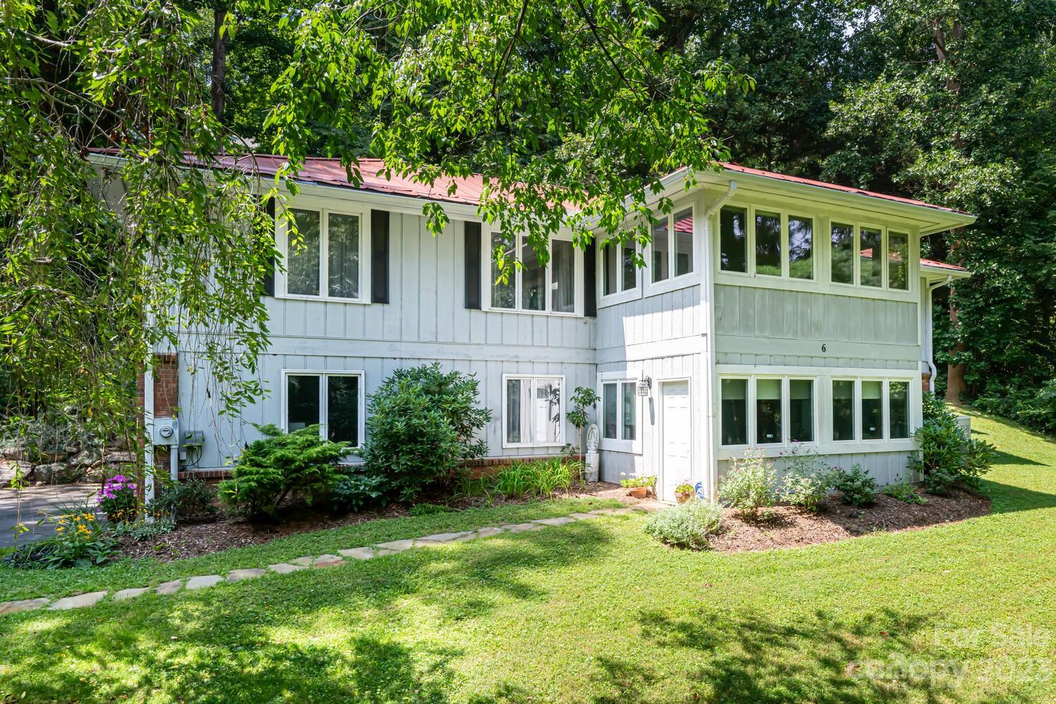 6 Cambridge Road Asheville, NC 28804 - Photo 2 of 35 a front view of a house with a yard and garage