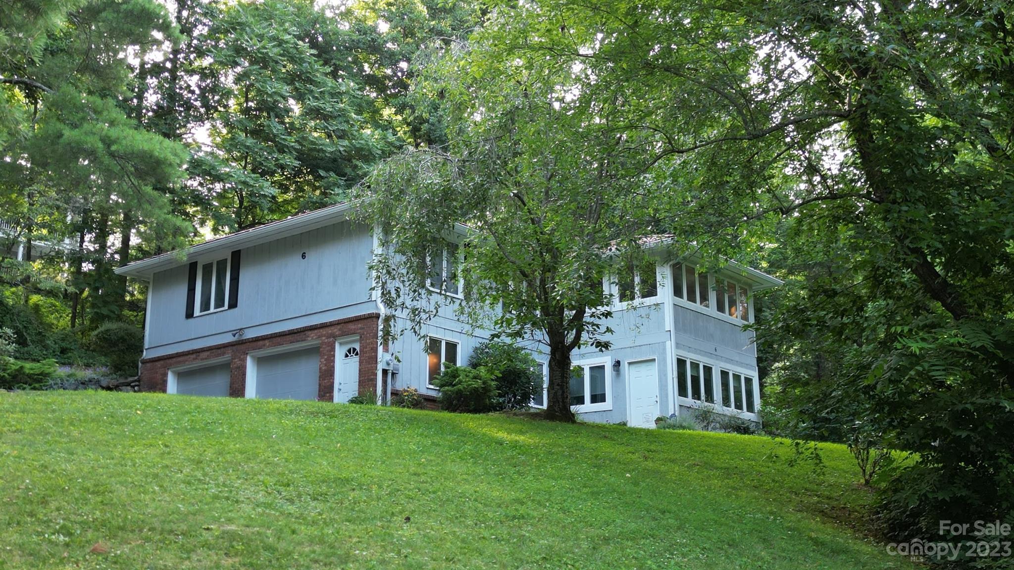 6 Cambridge Road Asheville, NC 28804 - Photo 3 of 35 a front view of a house with a yard and trees