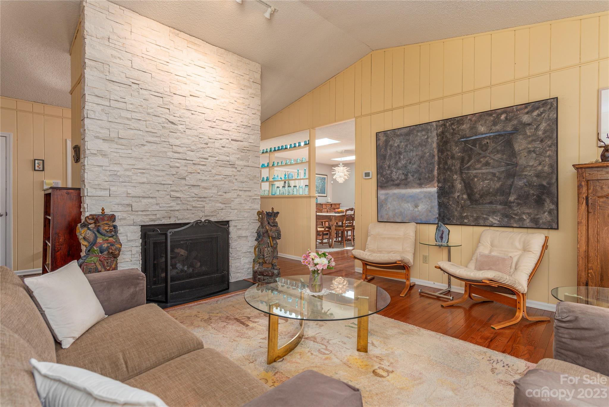 6 Cambridge Road Asheville, NC 28804 - Photo 6 of 35 a living room with furniture a fireplace and a floor to ceiling window
