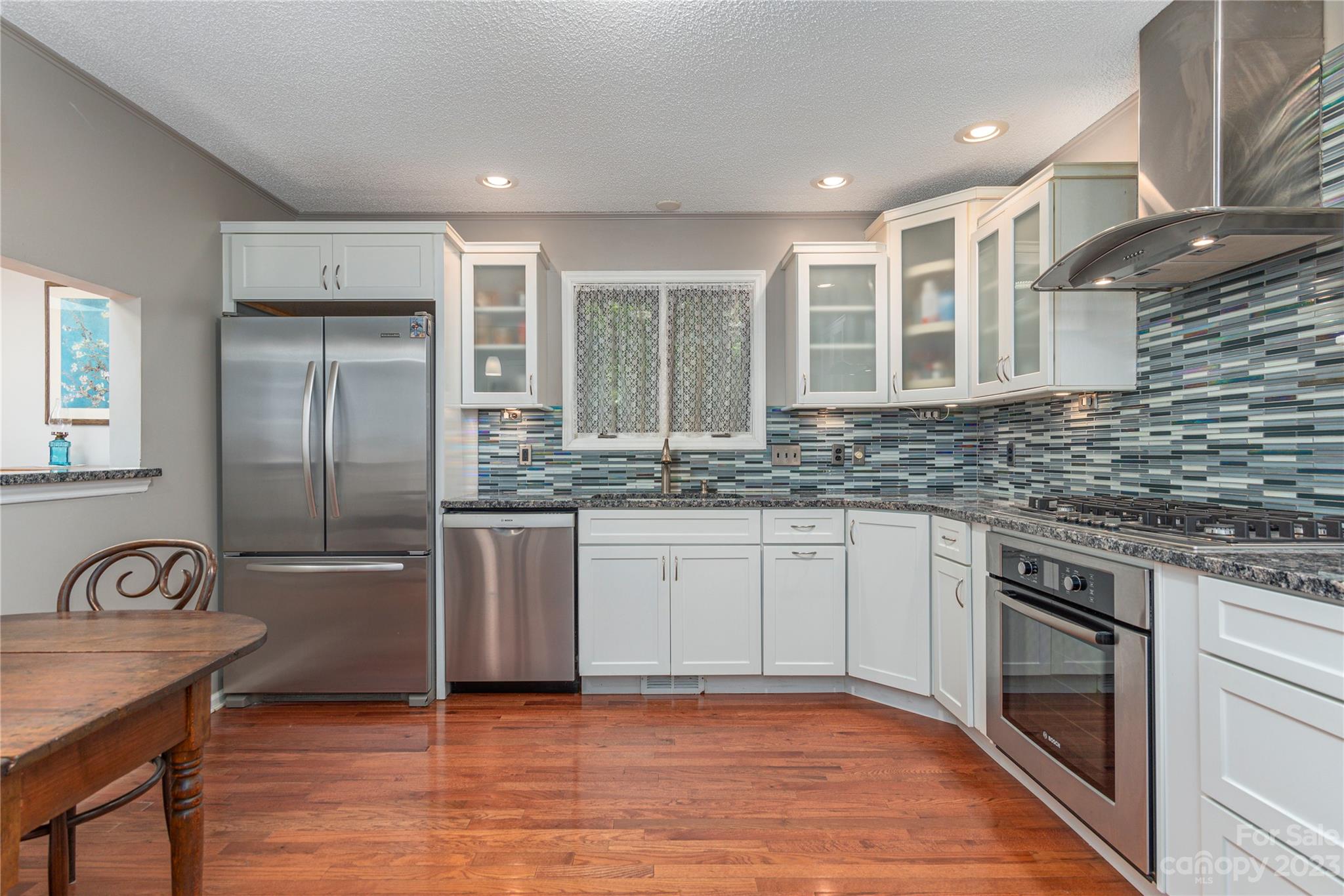6 Cambridge Road Asheville, NC 28804 - Photo 10 of 35 a kitchen with granite countertop a stove a sink and a refrigerator