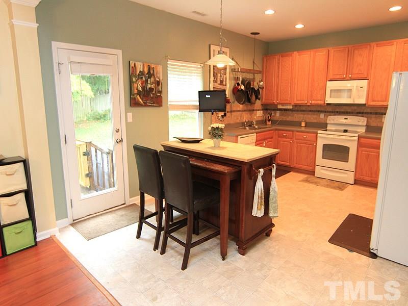 3505 Pinkham Way Raleigh, NC 27616 - Photo 11 of 24 a kitchen with stainless steel appliances granite countertop a table chairs sink and cabinets