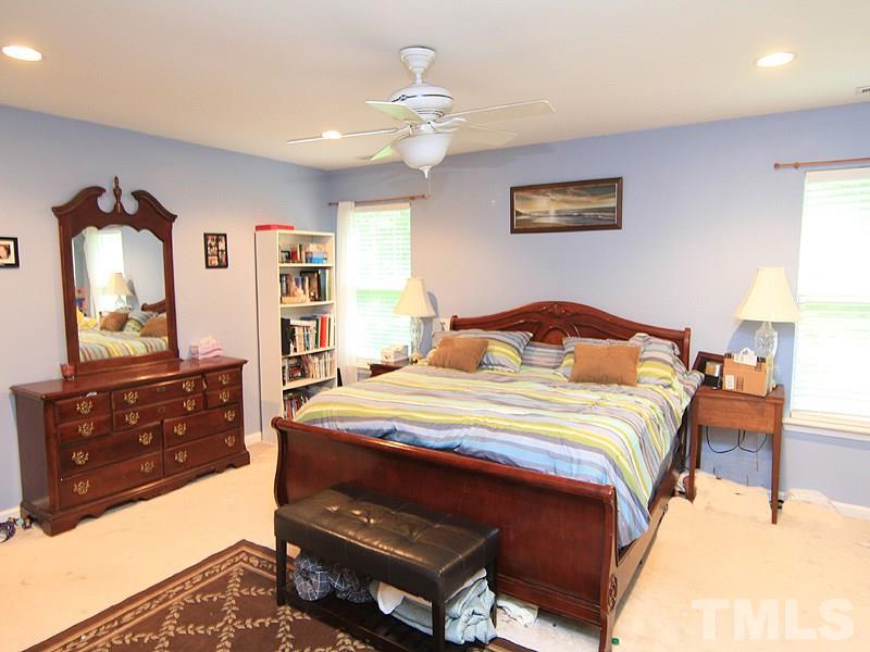3505 Pinkham Way Raleigh, NC 27616 - Photo 14 of 24 a bedroom with a bed and a dresser in it