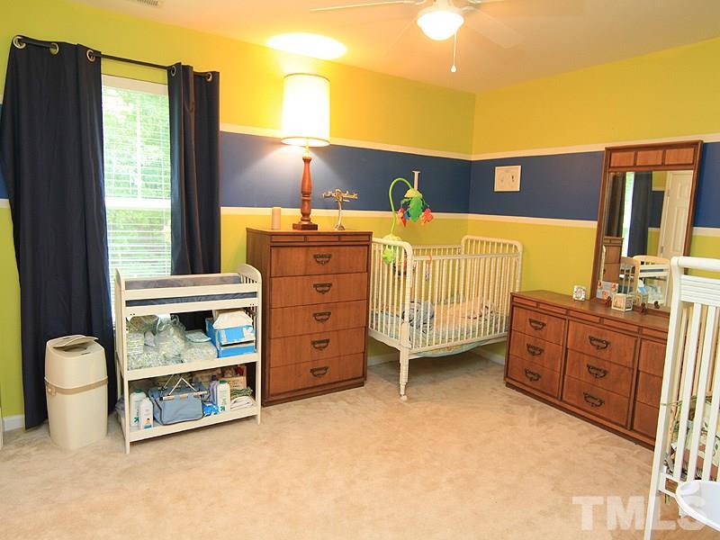3505 Pinkham Way Raleigh, NC 27616 - Photo 19 of 24 a bedroom with a bed and a cabinets