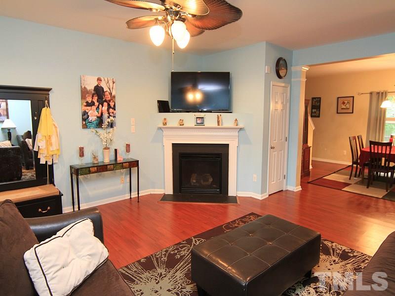 3505 Pinkham Way Raleigh, NC 27616 - Photo 4 of 24 a living room with furniture a flat screen tv and kitchen view