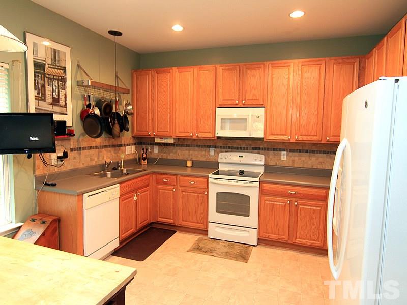 3505 Pinkham Way Raleigh, NC 27616 - Photo 5 of 24 a kitchen with stainless steel appliances granite countertop a stove a sink and a refrigerator