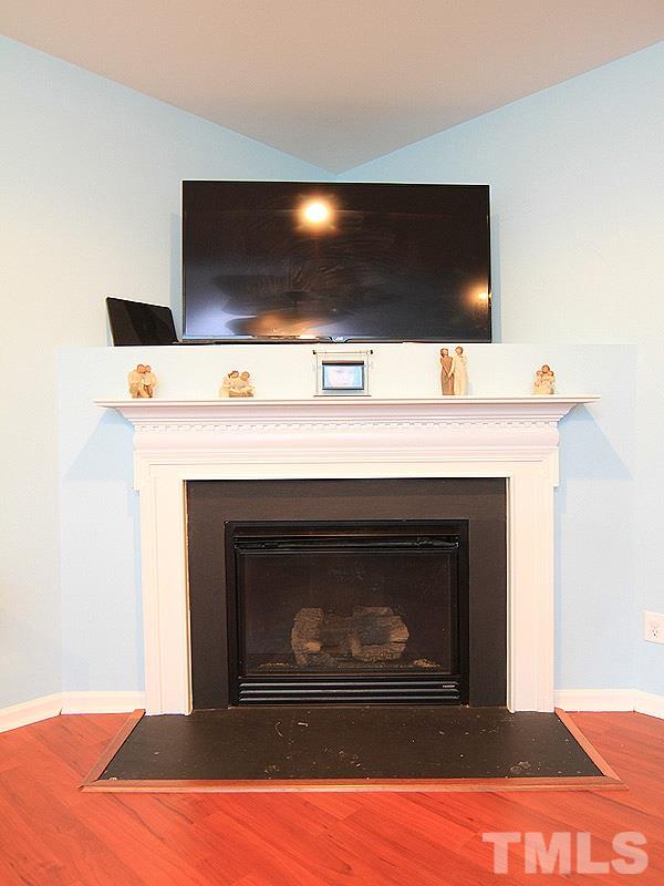 3505 Pinkham Way Raleigh, NC 27616 - Photo 6 of 24 a living room with a fireplace and a flat screen tv