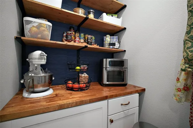 a kitchen with a refrigerator and a stove