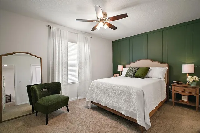 a bedroom with a bed and a couch