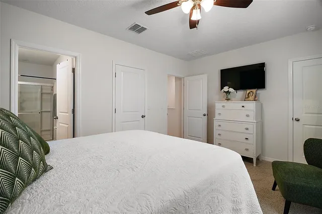 a bedroom with a bed and a flat screen tv