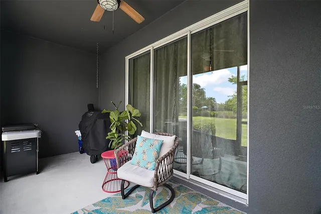 a porch with a table and chairs