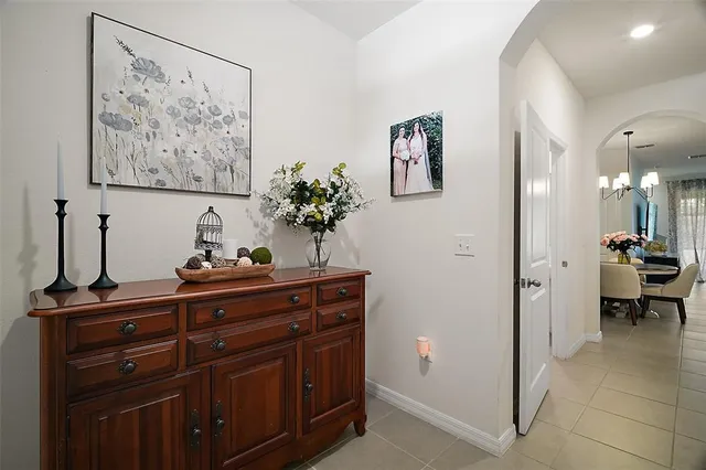 a view of room with painting on the wall and a potted plant