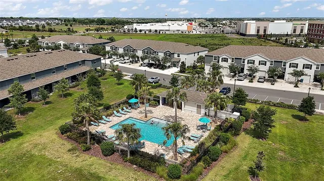 an aerial view of residential houses with outdoor space