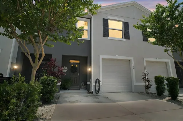 a view of a house with a yard and garage