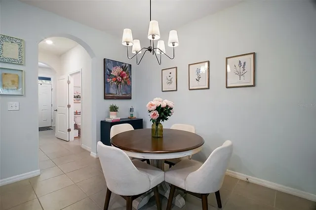 a dining room with furniture and chandelier