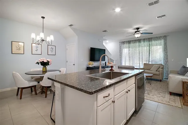 a kitchen with center island table and chairs