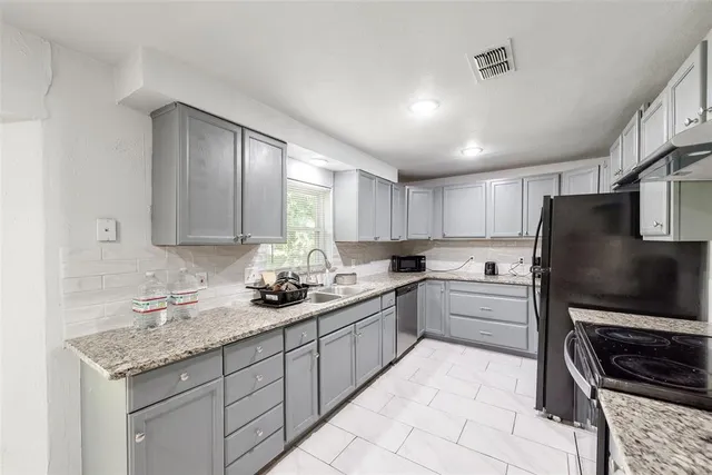 a kitchen with a sink stove and refrigerator