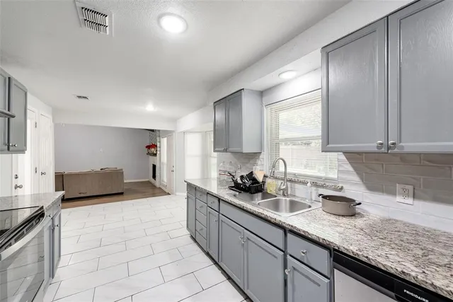 a kitchen with sink and cabinets