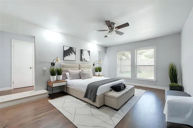 a bedroom with a large bed and a large window