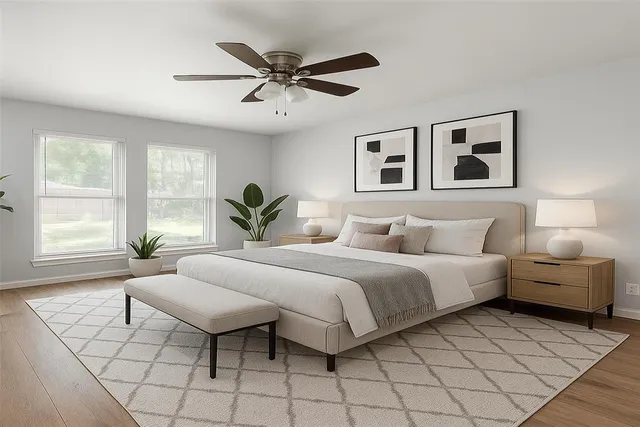 a spacious bedroom with a bed and window