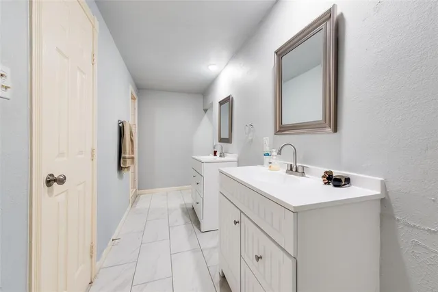 a spacious bathroom with a sink a mirror and a shower