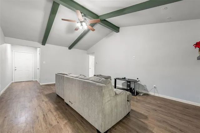 a living room with hard wood flooring and a table