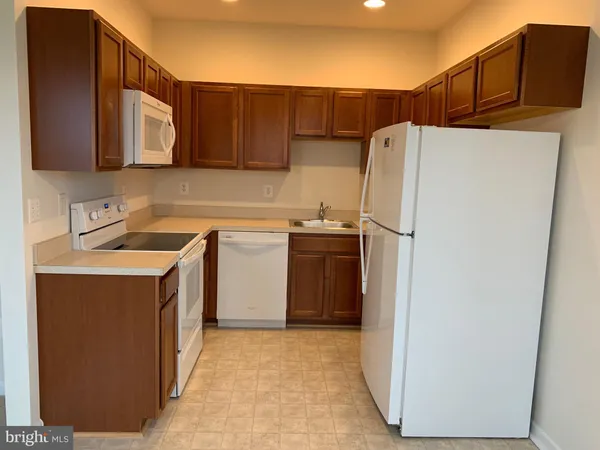 a utility room with cabinets washer and dryer