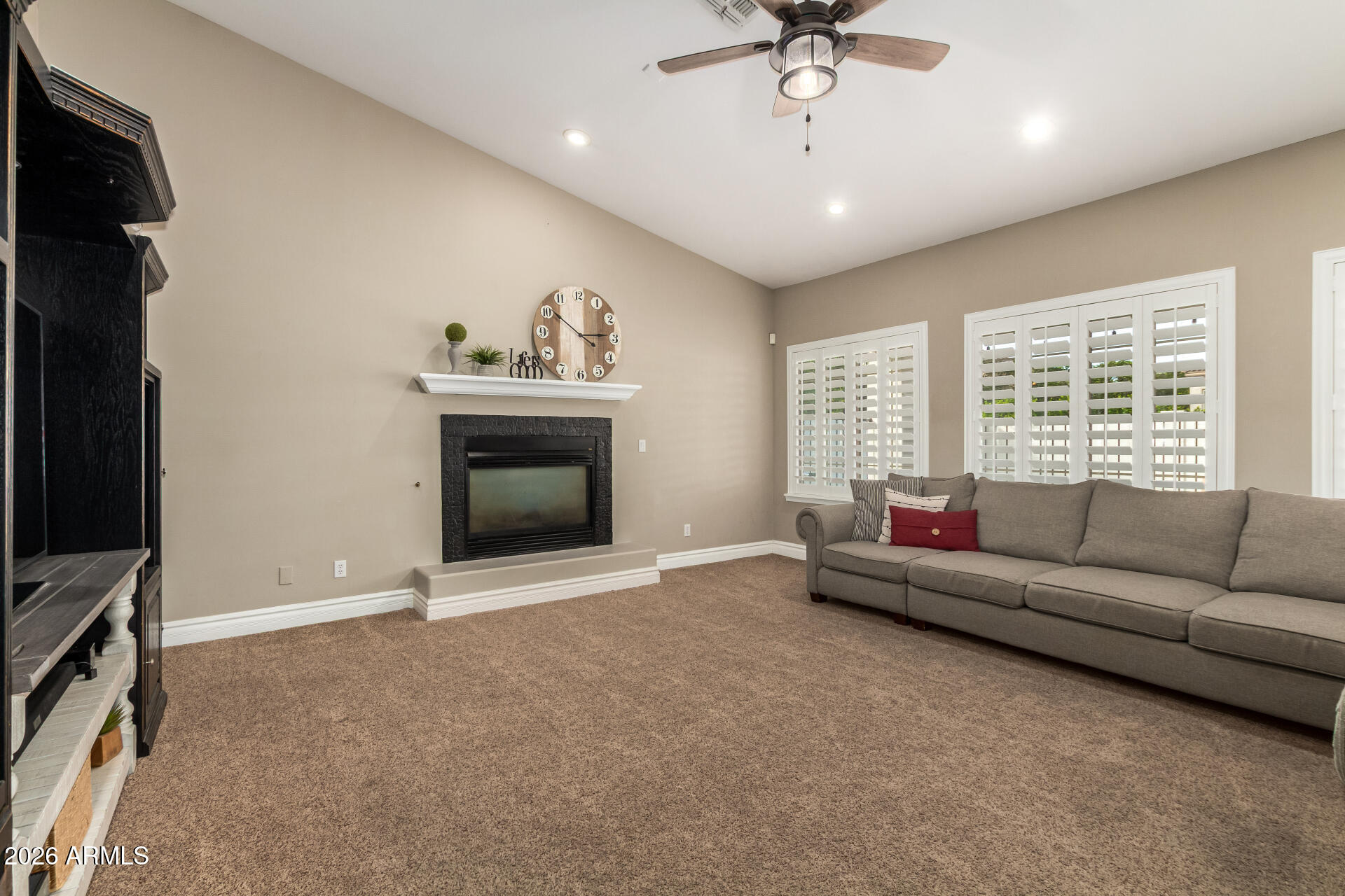 3528 East Decatur Street Mesa, AZ 85213 - Photo 11 of 55 a living room with furniture and a fireplace