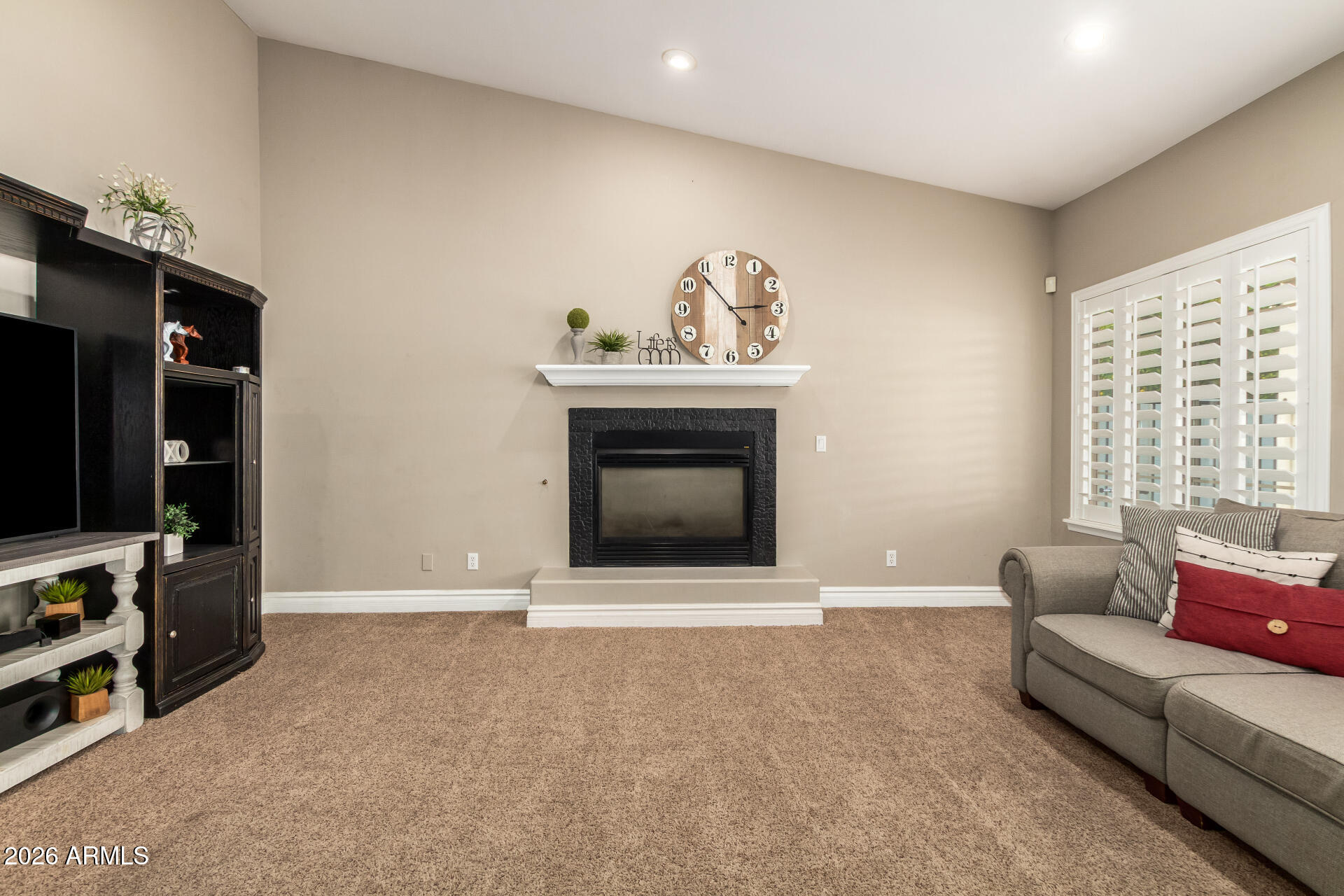 3528 East Decatur Street Mesa, AZ 85213 - Photo 13 of 55 a living room with furniture a flat screen tv and a fireplace